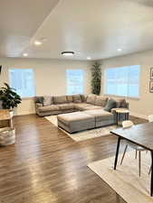 Living room featuring dark wood-type flooring and a textured ceiling