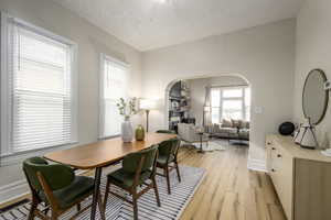 Dining room with a textured ceiling and light wood-type flooring