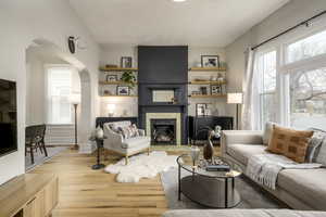 Living room featuring a textured ceiling and light wood-type flooring