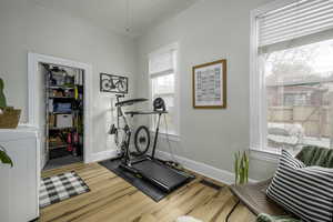 Workout room featuring washer / clothes dryer and hardwood / wood-style floors