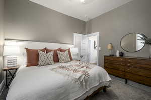 Carpeted bedroom featuring lofted ceiling