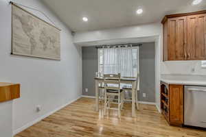 Dining area with light hardwood / wood-style flooring