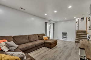 Living room with light hardwood / wood-style floors