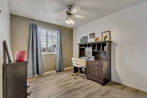 Office space featuring ceiling fan and light hardwood / wood-style flooring