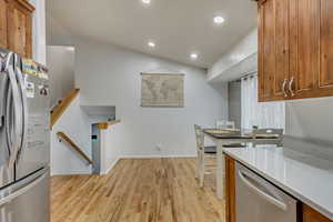 Kitchen with stainless steel appliances and light hardwood / wood-style flooring