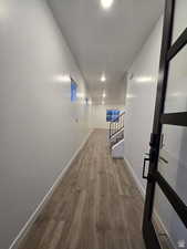 Corridor featuring wood-type flooring