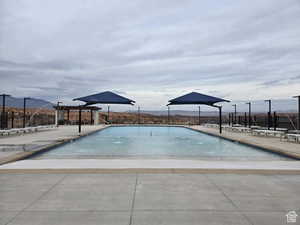 View of swimming pool with a pergola, a mountain view, and a patio