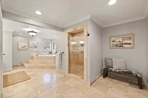 Bathroom with ornamental molding and independent shower and bath