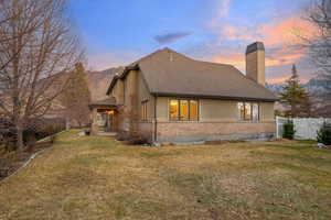 Property exterior at dusk with a lawn