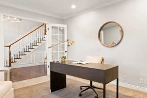 Home office featuring ornamental molding and hardwood / wood-style floors