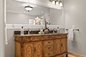 Bathroom with vanity and ornamental molding