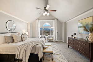 Bedroom featuring vaulted ceiling, light colored carpet, and ceiling fan