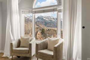 Living area with lofted ceiling, carpet flooring, and a mountain view