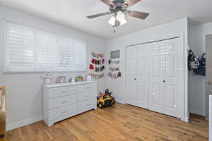 Bedroom featuring a closet, ceiling fan, and light wood-type flooring