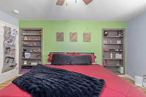 Bedroom with wood-type flooring and ceiling fan