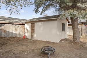 Back of house with an outdoor fire pit