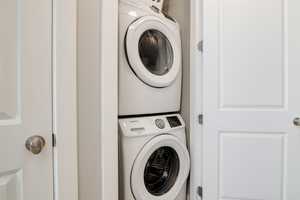 Clothes washing area featuring stacked washer / drying machine