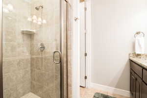 Bathroom with a shower with shower door and vanity