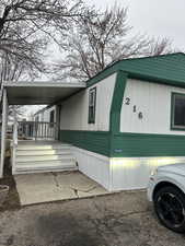 View of property exterior with a carport