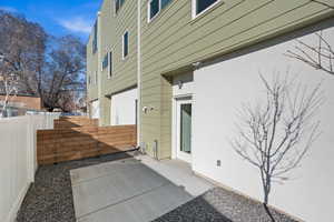 Rear view of house featuring a patio and fence