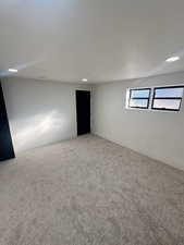 Carpeted empty room with a textured ceiling