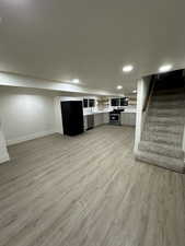 Interior space featuring black refrigerator and light hardwood / wood-style floors