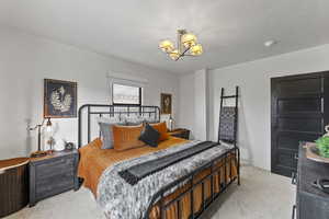 Carpeted bedroom with a textured ceiling