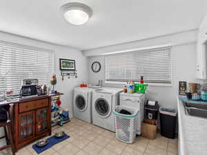 Laundry room featuring a wealth of natural light and washing machine and dryer