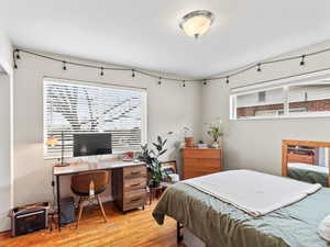 Bedroom with light hardwood / wood-style floors