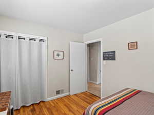 Bedroom with hardwood / wood-style flooring