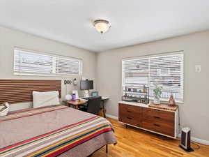 Bedroom with light hardwood / wood-style floors