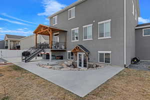 Back of property featuring a patio and a lawn