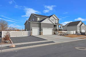 View of front of house featuring a garage and covered porch