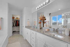 Bathroom with vanity and tile patterned flooring