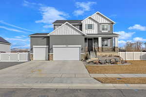 View of front of property featuring a garage and covered porch