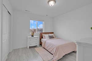 Bedroom featuring light wood-type flooring and a closet