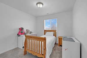 Bedroom with light colored carpet