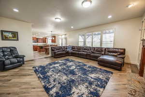 Huge great room with light hardwood / wood-style floors and gas fireplace