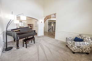 Formal living room with floor to ceiling windows looking out to front of property