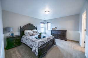 View of carpeted upstairs bedroom on opposite side of Jack and Jill bathroom