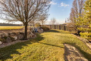 View of secluded terraced yard with retaining wall