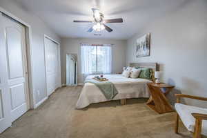 Another view of bedroom featuring two closets in upstairs