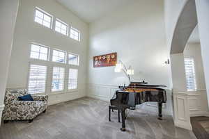 Formal living area / music room featuring a high ceiling located off main foyer