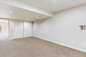 Basement with baseboards, carpet flooring, and recessed lighting