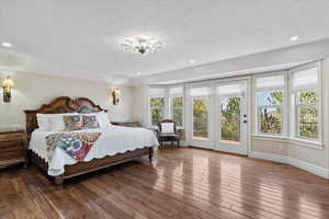 Bedroom with access to outside, recessed lighting, and wood-type flooring