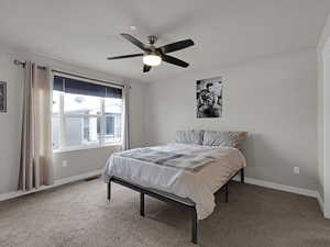 Bedroom featuring ceiling fan and carpet flooring