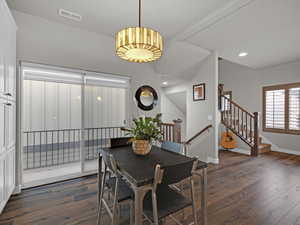 Dining space with dark hardwood / wood-style flooring