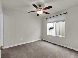 Unfurnished room featuring ceiling fan and carpet floors