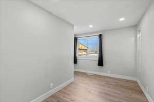 Empty room featuring light hardwood / wood-style flooring