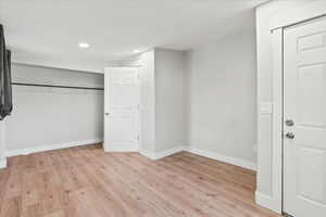 Unfurnished bedroom with a closet and light hardwood / wood-style flooring